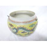 A Chinese famille jeune circular hanging jardiniere with painted dragon decoration on yellow ground,