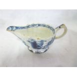 A late 18th Century china sauceboat with blue and white painted decoration