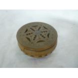 A 19th Century Eastern circular sandalwood cricket box with pierced decoration