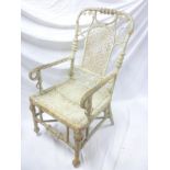 A 19th Century ornate cane-work conservatory chair with decorated arched back (af)