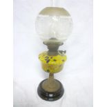 A Victorian brass oil lamp with yellow and blue speckled glass reservoir and etched glass shade