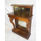 An early 19th Century carved rosewood rectangular pier cabinet with mirror panel backs,