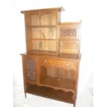 A late Victorian/Edwardian carved oak side cabinet with a single frieze drawer flanked by cupboard