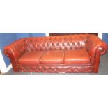 A three seat Chesterfield sofa upholstered in red buttoned leather (af)