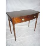 A Victorian mahogany rectangular bow fronted side table with a single drawer in the frieze on