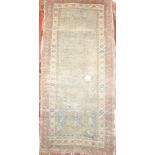 A 19th Century Eastern hand knotted wool rug with geometric decoration (af) 65" x 29 "