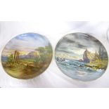 A pair of large Continental pottery circular wall plaques decorated with classical coastal scenes,