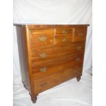 A Victorian walnut chest of drawers with two small central drawers flanked by two deep drawers