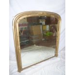 A Victorian arched over mantel mirror in gilt relief decorated frame 43" high