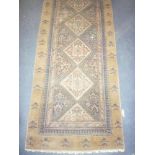 A 19th Century Eastern hand-knotted wool runner with geometric decoration on blue and brown ground