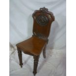 A Victorian carved mahogany hall chair,