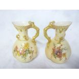 A pair of Royal Worcester ornamental china ewers with painted floral decoration and gilt rustic