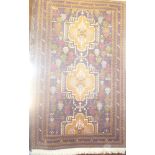 An Eastern hand-knotted wool rug with geometric decoration on blue ground 72" x 44"