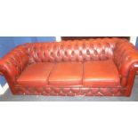 A three seat Chesterfield sofa upholstered in red buttoned leather (af)