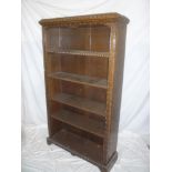 A good quality carved oak open bookcase with adjustable shelves on bracket feet