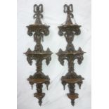 A pair of ornate Victorian carved mahogany four-tier graduated wall shelves with carved scroll