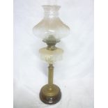 An Edwardian brass oil lamp with clear glass reservoir and tapered shade