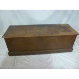 An old stained teak rectangular trunk with hinged lid