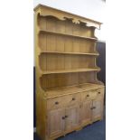 A 19th Century polished pine kitchen dresser with two drawers in the frieze and cupboard enclosed