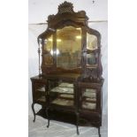 A late Victorian mahogany parlour display cabinet with three fabric lined cupboards enclosed by