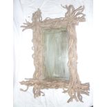 An unusual rectangular wall mirror in rustic tangled vine frame,