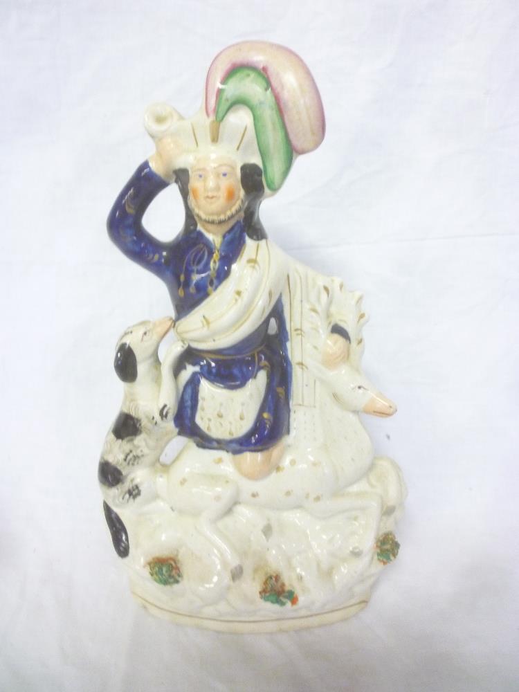 A Victorian Staffordshire pottery figure of a male with dog and deer