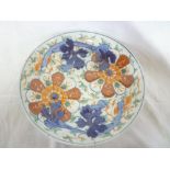 A 19th Century Japanese pottery circular charger with painted floral decoration (af)