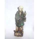 A 19th Century Chinese glazed terracotta figure of a male in ceremonial robes holding a vase 14"