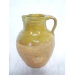 A 19th Century glazed terracotta tapered jug with loop handle