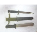 A United States combat knife in composition scabbard and a divers knife with rubber handle (2)