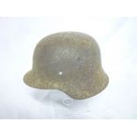 A Second War German steel helmet in relic condition minus liner