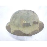 An original British First War raw-edge Brodie steel helmet with traces of original fibre finish and