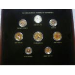 A 2001 gilt and enamelled 8-piece decimal coin set in cabinet box