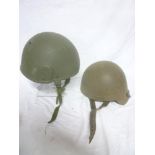 A NATO combat helmet with liner and chin strap and a composition tank-style helmet (2)
