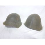 A Russian Soviet Forces steel combat helmet and an Eastern Block steel combat helmet (2)