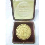 A 1909 Imperial International Exhibition gilt presentation medallion "Presented in Commemoration of