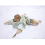 A Victorian automata clockwork swimming doll with celluloid head, painted tinplate arms,