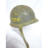 A Second War United States steel combat helmet with liner and chin strap,