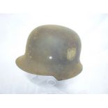 A Second War German steel helmet with remains of an original decal,