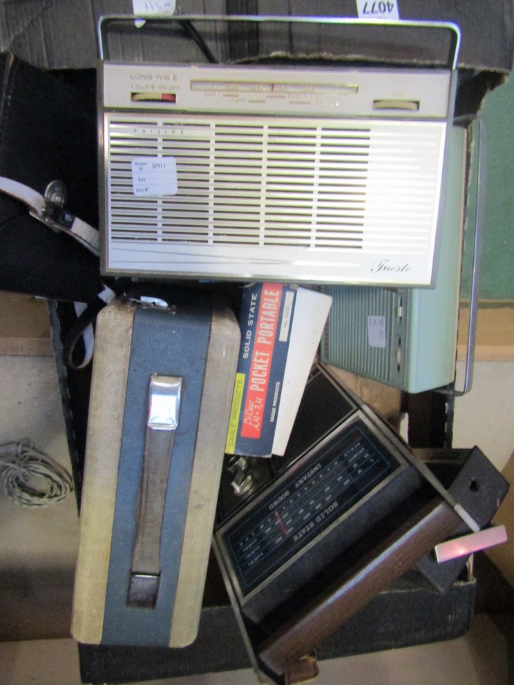 A box of vintage transistor radios including Anglia,