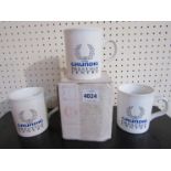 Three Grundig coffee mugs and an LG mug