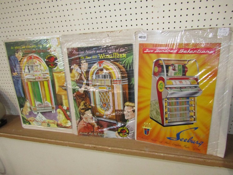 Three reproduction metal jukebox signs to include Wurlitzer and Seeburg