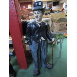 A figure of Charlie Chaplin standing with cane,