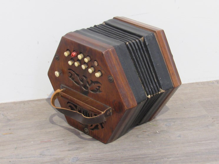 A late 19th Century German walnut concertina, pierced lyre ends,