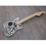 A Little Lyon zebra design ¼ size electric guitar with inbuilt amp,