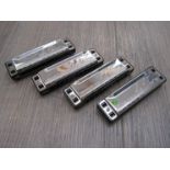 Four Lee Oskar by Tombo harmonicas consisting of MM G, MM C,
