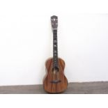 A tenor ukulele with mother of pearl inalid frets and head,