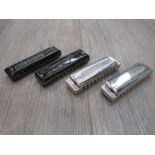 Four Suzuki harmonicas consisting of Overdrive G,