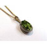 A 9ct gold diamond and peridot pendant hung on chain, 46cm chain, 3.