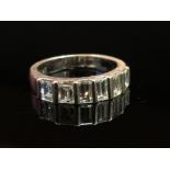 An 18ct white gold ring set with six baguette cut diamonds, size N, 5.
